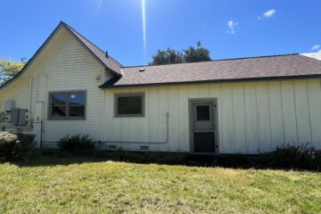 Exterior of a pale yellow house with gray trim